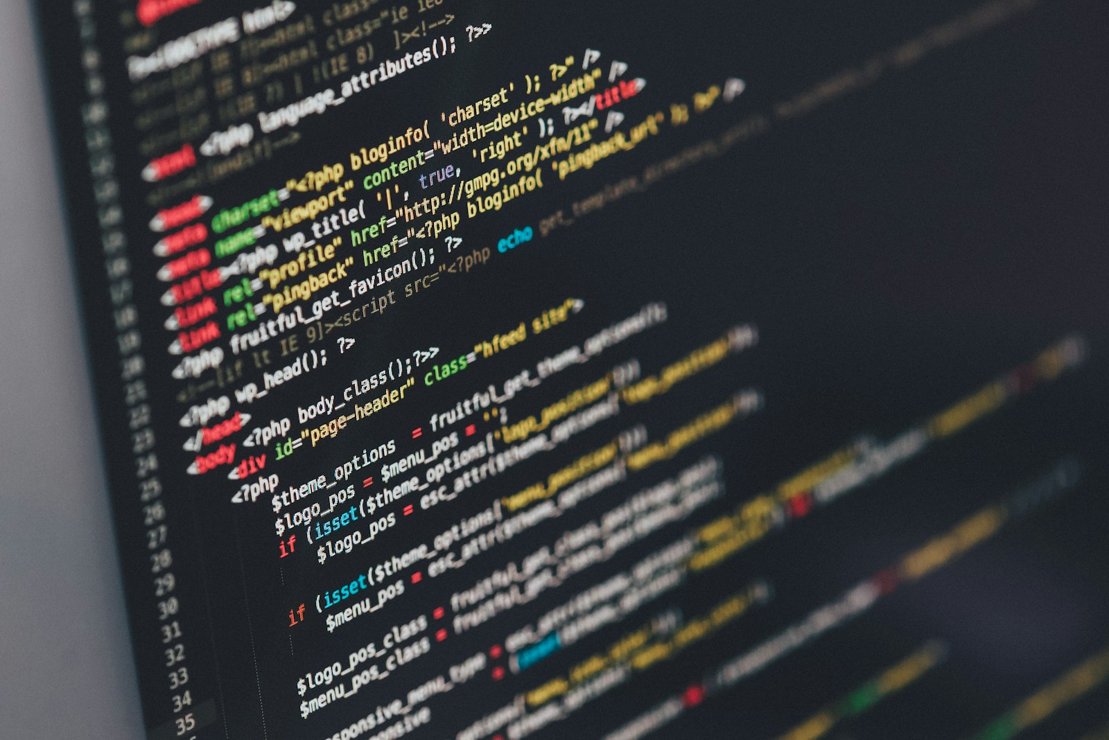 Developer at a dual-monitor desk deep in a late-night coding session reviewing a diff alongside an AI agent chat